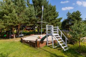 a playground with a ladder and a slide at Słoneczna Przystań in Sasino