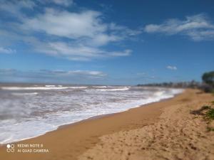 a sandy beach with the ocean in the background at PÔR Do SOL BEACH in Marataizes +2 photos
