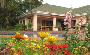 a garden of flowers in front of a house at 12 FLEETWOOD in Harare