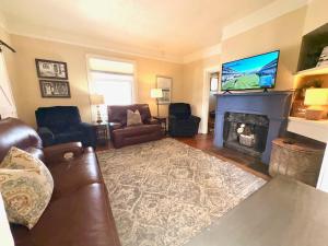 a living room with a couch and a fireplace at Garden City House with Hot Tub in Colorado Springs