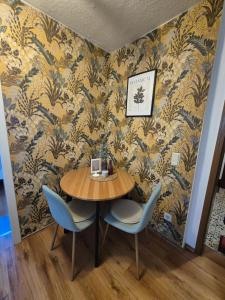 a dining room with a table and two chairs at Gästehaus Kampik in Witten +25 photos