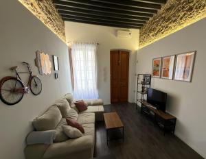 a living room with a couch and a bike on the wall at LOFT La Palma in Almería