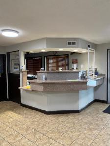a kitchen with a counter in a room at Ramada by Wyndham Sioux Falls in Sioux Falls