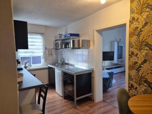 a small kitchen with a table and a dining room at Gästehaus Kampik in Witten