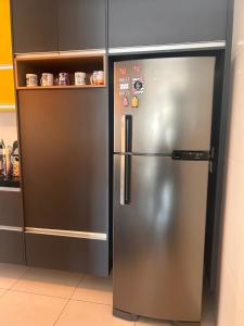 a stainless steel refrigerator in a kitchen at Ilha Salinas Canto do Forte in Praia Grande