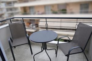 a table and two chairs on a balcony at GoCity apartments in Volos