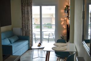 a living room with a couch and a table and chairs at GoCity apartments in Volos +59 photos