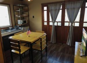 a kitchen with a wooden table with an american flag on it at Cabañas Ventalia in El Calafate