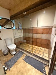a bathroom under construction with a toilet in it at Stormsriver Backpackers Dijembe in Stormsrivier +65 photos