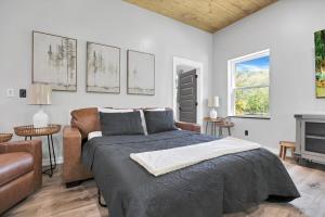 a bedroom with a bed and a couch at Pine Grove Barndominium in Sugar Grove +177 photos