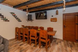 a dining room with a wooden table and chairs at Villa Nancy with jacuzzi in Benkovac +16 photos