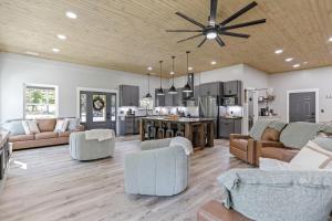 a living room and kitchen with a ceiling fan at Pine Grove Barndominium in Sugar Grove