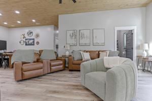 a living room with two couches and a table at Pine Grove Barndominium in Sugar Grove