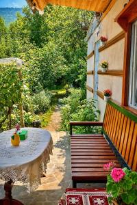 a table and bench on a balcony with a window at The Secret Garden House in Ijevan