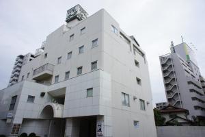a white building next to a tall building at Kawasaki Hotel Park in Kawasaki