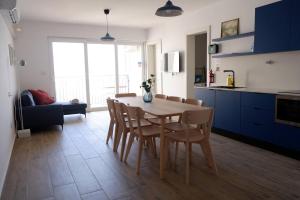 a kitchen and dining room with a table and chairs at Peprina Apt 2 in Central Rabat in Rabat +17 photos