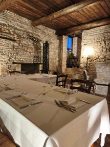 a dining room with a white table with utensils at Castello di Petecciano B&B in Mosciano SantʼAngelo +56 photos