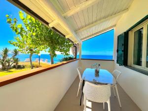 a balcony with a table and chairs and a view of the ocean at Residence Araba Fenice Tropea in Tropea