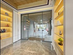 a hallway with a glass door in a building at Osaka Riverview PIK2 By Micky Studio 3 in Rawalumpang