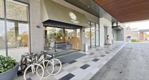 a group of bikes parked outside of a building at Osaka Riverview PIK2 By Micky Studio 3 in Rawalumpang +3 photos