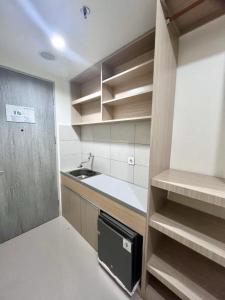 a small kitchen with a sink and a counter at Osaka Riverview PIK2 By Micky Studio 3 in Rawalumpang