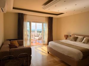a bedroom with a bed and a couch and a balcony at CASABA - Boutique - Torre del Mar in Torre del Mar +35 photos