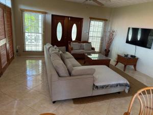 a living room with a couch and a tv at Casa Vista in Marigot Bay