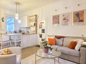 a living room with a couch and a table at Le Haussmann - Centre Historique, Chic & Terrasse in Saint-Brieuc