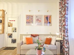 a living room with a couch and a table at Le Haussmann - Centre Historique, Chic & Terrasse in Saint-Brieuc