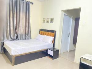 a small bed in a room with a window at Elite Hotel in Ekpoma +2 photos