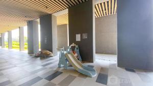 a childrens play area with a slide in a building at Osaka Riverview PIK2 By Micky Studio 4 in Rawalumpang +2 photos