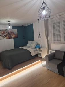 a bedroom with a bed and a couch at PaulAngela in Avignon