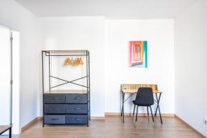 a room with a desk and a chair and a table at Romantic getaway with Jacuzzi, Downtown in Mulhouse