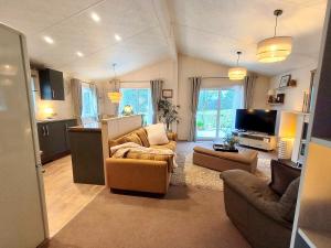 a living room with two couches and a tv at 10 lochview in Moffat