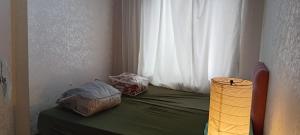 a bed with two bags on it with a window at Alyakek Apartment in Istanbul