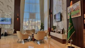 a lobby with a table and chairs and a large window at فندق نوفا ليس للخدمات الفندقيه in Najran