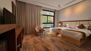 a hotel room with two beds and a window at فندق نوفا ليس للخدمات الفندقيه in Najran