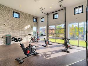 a fitness room with several exercise bikes in it at Your Dream Apartment Stay in Kissimmee