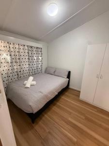 a bedroom with a bed with two white towels on it at Upper Esplanade Oceanview Escape in Bunbury