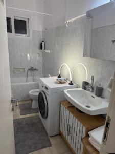 a bathroom with a washing machine and a sink at Dimitras Apartment with 3 bedrooms Elefsis in Eleusis +14 photos
