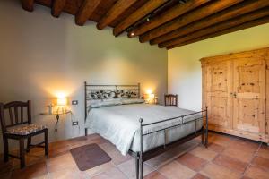 a bedroom with a bed and a wooden ceiling at Il Salice Country Luxury in Due Carrare +99 photos