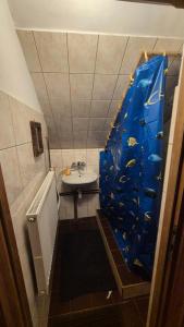 a bathroom with a fish mural on the wall at Limba in Ząb +15 photos
