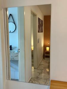 a mirror in a room with a hallway at Charlotte Beach Inn in Mangaratiba