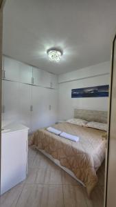 a bedroom with a bed and a chandelier at Apartment 1 by Villa Ceni in Elbasan