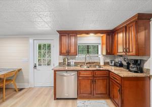 a kitchen with wooden cabinets and a sink at Rustic Lodge - Pet-Friendly Cabin with Hot Tub & Fire Pit in Pigeon Forge