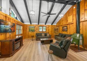 a living room with wood paneling and a ceiling at Rustic Lodge - Pet-Friendly Cabin with Hot Tub & Fire Pit in Pigeon Forge