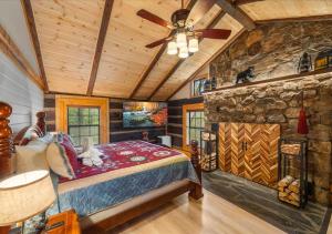 a bedroom with a bed in a room with a stone wall at Rustic Lodge - Pet-Friendly Cabin with Hot Tub & Fire Pit in Pigeon Forge