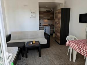 a small living room with a couch and a table at vila matejevic in Star Dojran