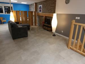 a living room with a couch and a television at Appartement original tout confort in Condamine +10 photos