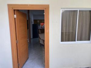 a door leading into a room with a window at ajmicasita in Constanza